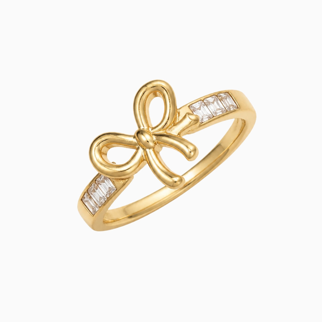 Gold-tone stainless steel bow ring with rectangular clear stones on the
band