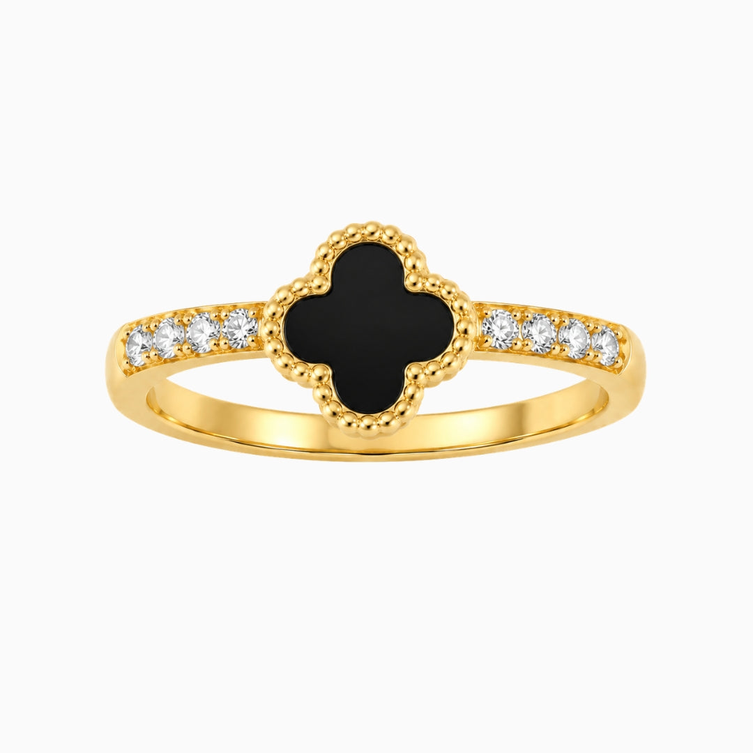  Gold-tone stainless steel ring with a black clover motif and small clear
stones on the band
