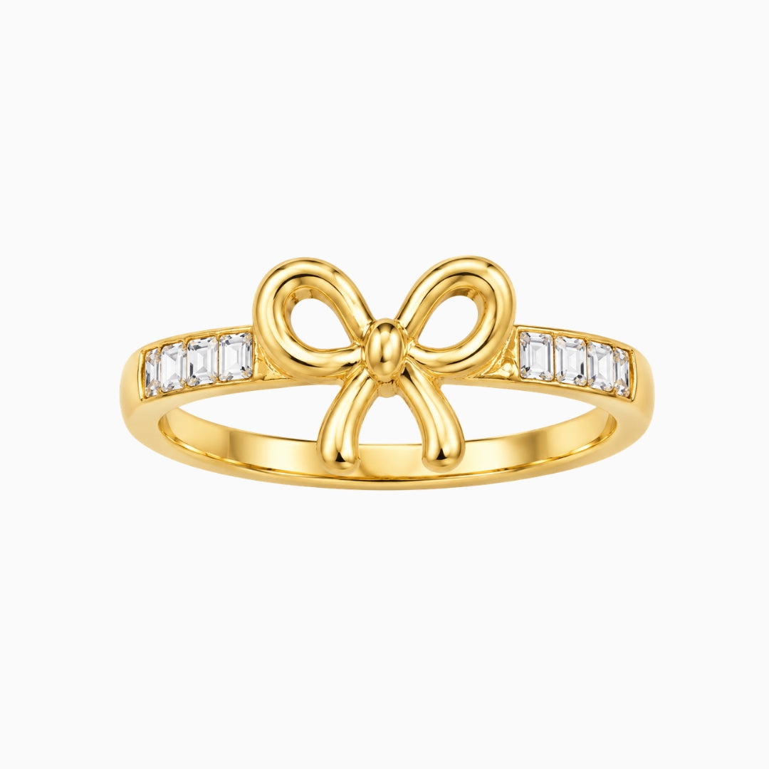 Gold-tone stainless steel bow ring with rectangular clear stones on the
band
