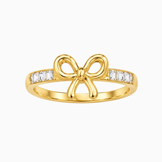 Gold-tone stainless steel bow ring with rectangular clear stones on the
band