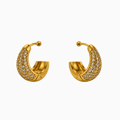 Pair of chunky gold-tone stainless steel huggie hoop earrings covered in small clear stones