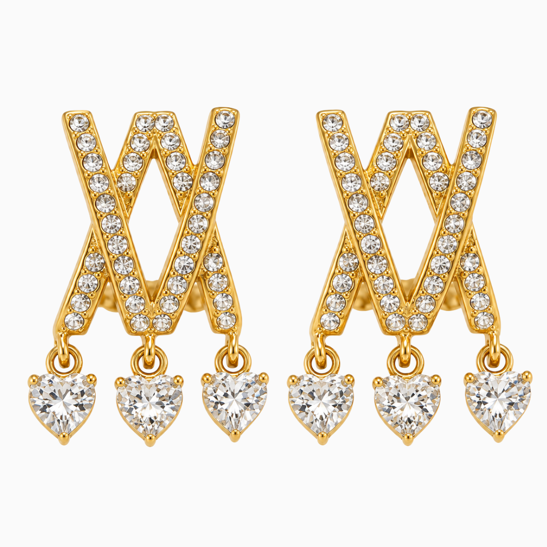 Pair of gold-tone stainless steel criss-cross earrings with three heart-shaped clear stone drops