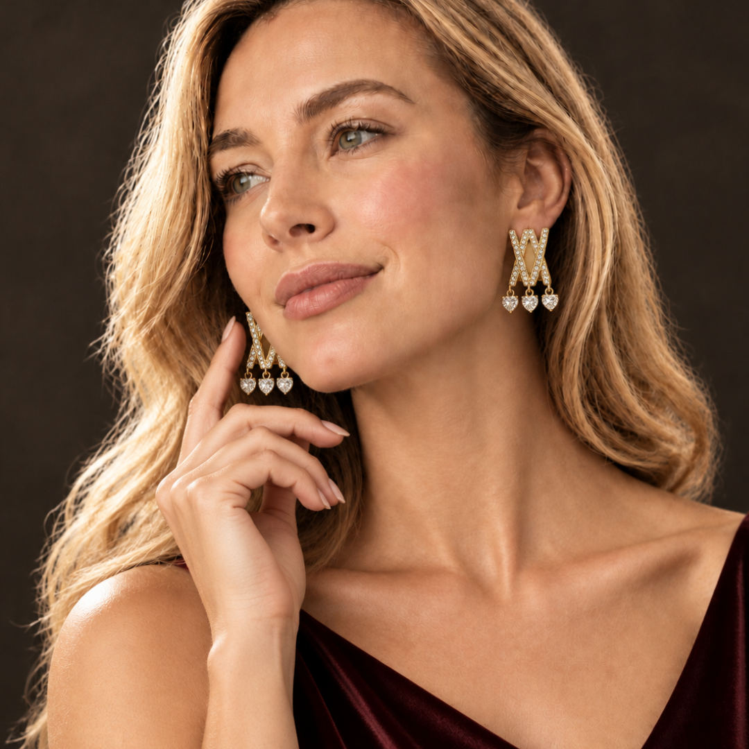 Criss-cross heart drop earring worn on an ear