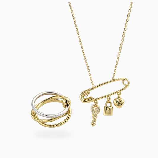 Gold-tone stainless steel safety-pin necklace with key, lock and heart charms, shown with a layered ring
