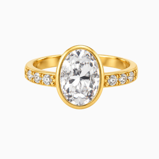  Gold-tone stainless steel ring with a large oval clear stone and small side
stones