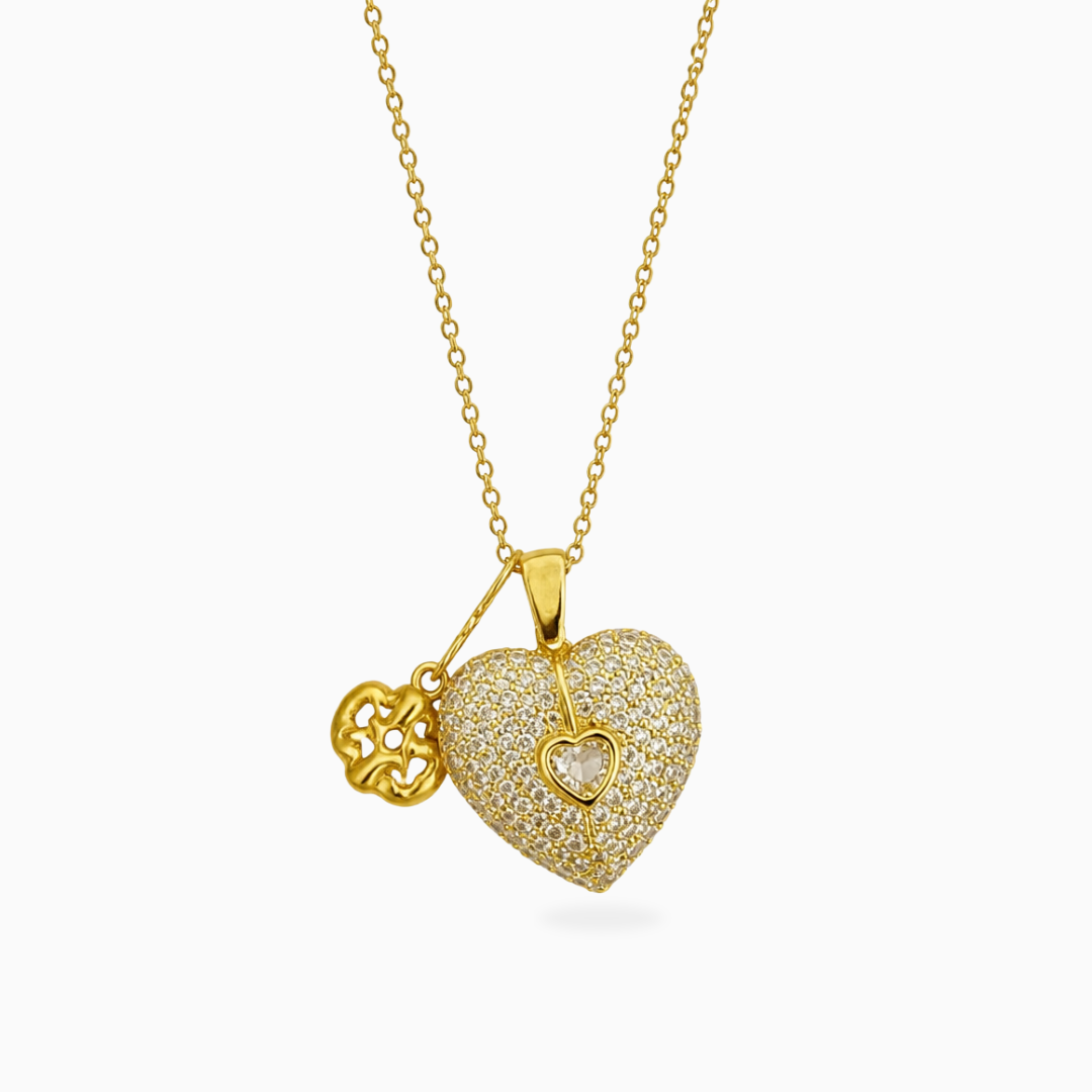 Gold-tone stainless steel necklace with a clear stone pavé heart pendant and a small flower charm
