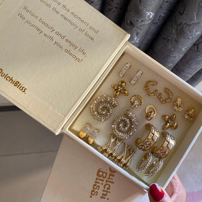 Pair of textured gold-tone spiral earrings with clear stones and pearl-style beads