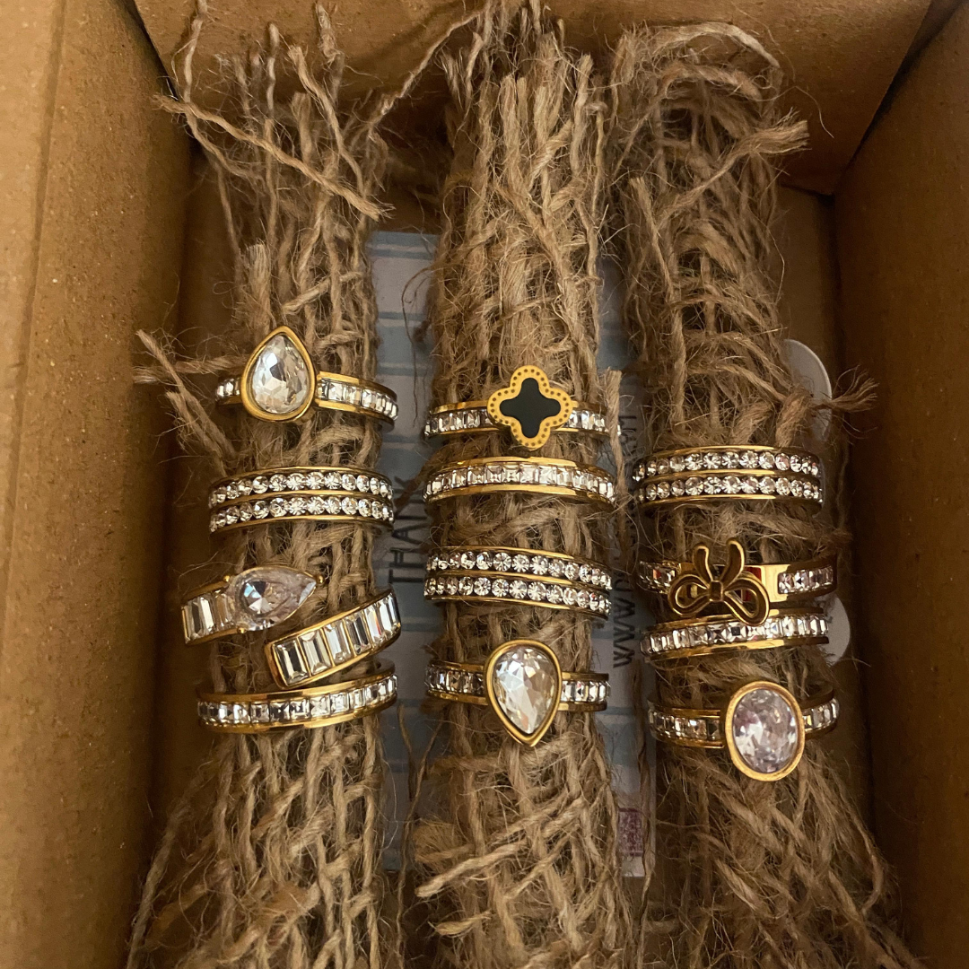 close-up of square-cut clear stones in a single row on a gold-tone stainless steel band rings