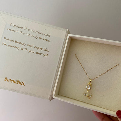 Gold-tone stainless steel tulip necklace laid flat showing the pendant and fine chain