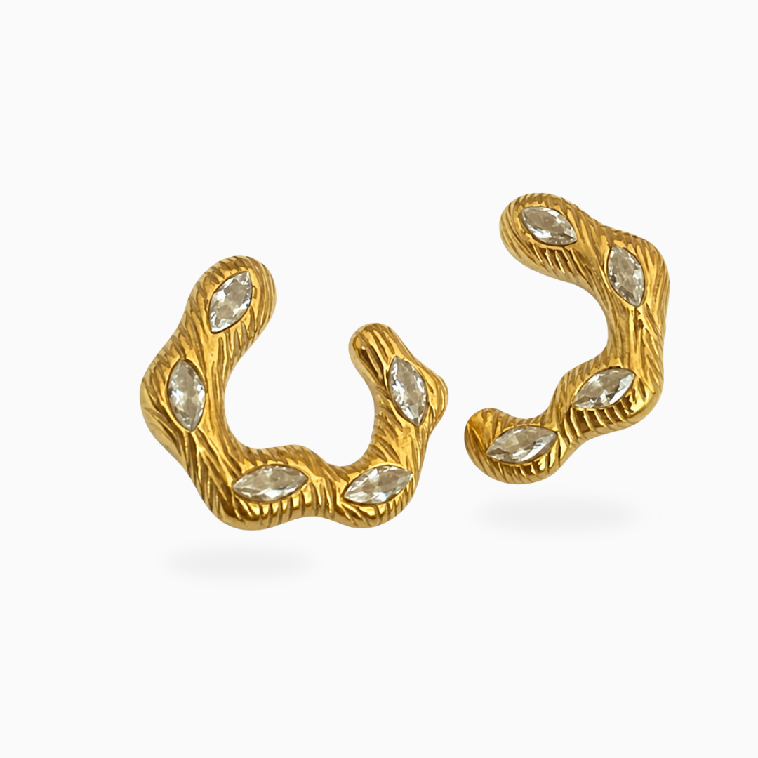 Pair of wavy textured gold-tone stainless steel earrings set with marquise-shaped clear stones